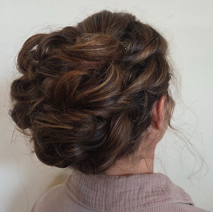 A bridal updo with pinned curls by an Empire Salon stylist